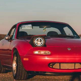A Miata with the plate showing through the windshield.